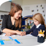 Education Support worker helping child in classroom