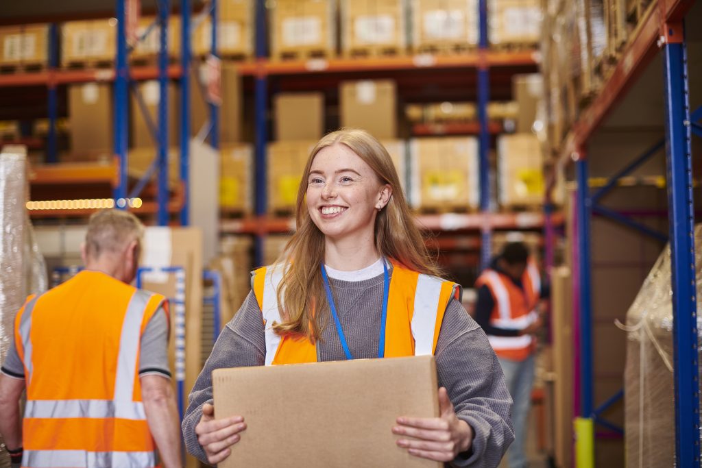 Happy young warehouse worker